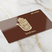 Gift voucher with Hamsa hand design on a marble surface