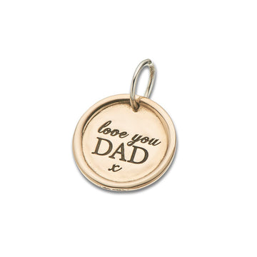 Round brass charm with silver bail and text "love you dad X"